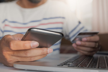 Online payment,Man's hands holding smartphone and using credit card for online shopping. Cyber Monday Concept