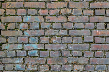 Old brickwork. Classic wall texture. Brick wall with moss between the bricks. Rough brick texture
