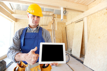 Construction worker holding tablet