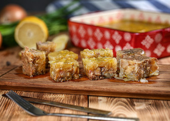 Jelly with meat, beef aspic, traditional Russian dish, portion on a plate, mustard and horseradish