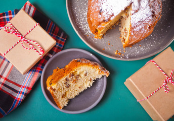 Traditional Christmas cake panettone with fruits and nuts with Christmas decoration