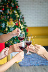 Friends celebrating Christmas or New Year eve party with Bengal lights and champagne.