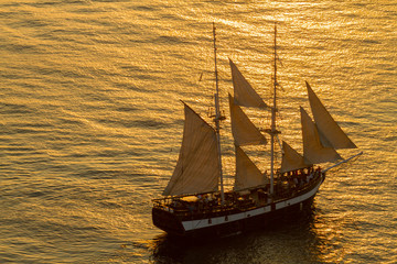 Beautiful sunset with the sailboat in the front. Taken in Santorini Greece august 2013