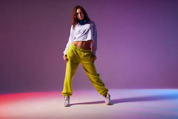 Pretty attractive female standing on white floor of dance studio, looking at camera, ready to start...