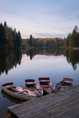 four boats on lake on an evening in fall