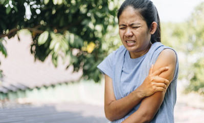 Naklejka na ściany i meble Young Woman Suffering From Painful Feeling In Arm Muscles , Health Care Concept