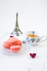 Closeup french sweet macaroons rose on wooden table