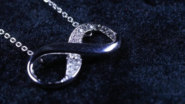 Macro close up of infinity necklace jewelry rotating around