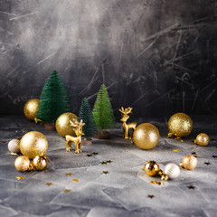 Golden christmas balls and stars on dark background