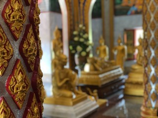Buddhist temple inside. golden Asian drawings, Buddha statues, nauion arnaments