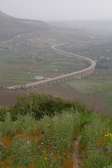 Reduced visibility at a motorway bridge in Sicily during Calima, a weather condition when Sahara dust brought by wind is in the air