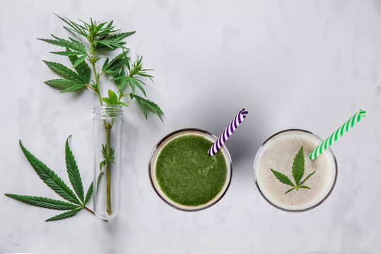 Concept Edibles CBD And Drinks With Cannabis . Glasses With Fresh Beverage, Milk And Smoothies, With Hemp. Flat Lay