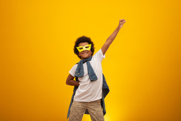 Portrait of a young, mixed race boy dressed as a superhero. Black baby in super hero costume. The...