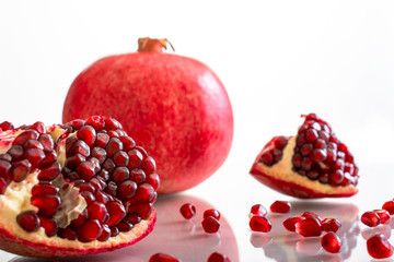 Ripe pomegranate fruit  on white background cutout