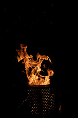 Hot flame of fire with sparks on a black background