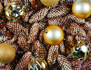 Golden Christmas balls and pine cones. Christmas background