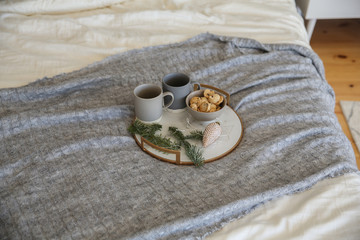 Tray with tea and cookies on the bed