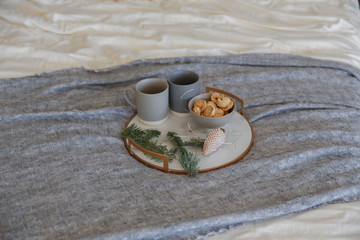 Tray with tea and cookies on the bed