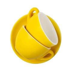 Top view on yellow cups and saucers isolated on white