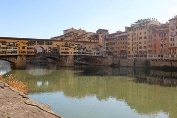 Fototapeta premium View to ponte vecchio in florence and its reflection in Arno river