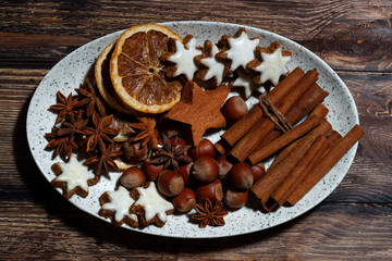 Fototapeta na wymiar spices and christmas cookies on a dish, top view