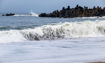 peaceful North Sea landscape with small waves and stone pier