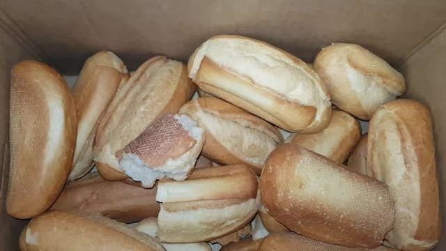 Collecting stale bread in a cardboard box for recycling in culinary products or for feeding animals