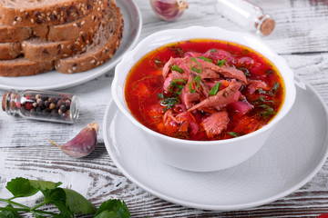 Borscht soup with meat in a white bowl. Ukrainian cuisine meal