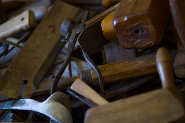 Old tools in a wooden crate. Planers, pliers, drills, hammers and other joinery needs.
