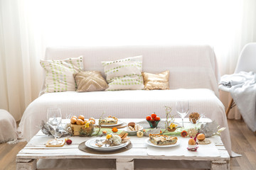 The interior of the room with a festive Easter table .