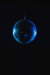 Mirror disco ball under the ceiling in a nightclub.