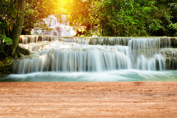Wood table top on beautiful waterfall background