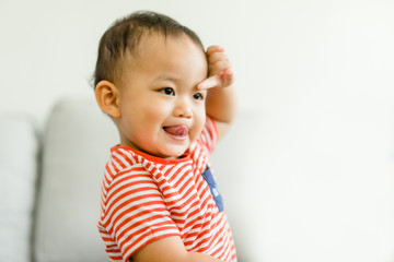 2 year old toddler asian boy uncontrollable and bad behavior and show funny face at home.Attention...