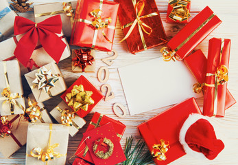 Christmas background - red and craft paper gift boxes decorations with gold ribbon on white background. top view