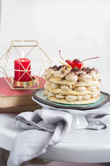 traditional delicious tiramisu and candles in the background