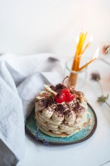 traditional delicious tiramisu and candles in the background