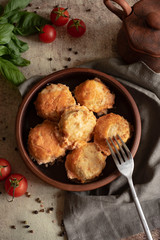 Tender meat meatballs in tomato sauce in a stylish clay plate. Vertical photo