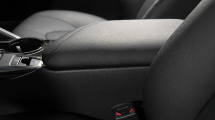 armrest in the driver's car is upholstered in eco-leather. beautiful leather car interior design. luxury leather seats in car. Black leather seat covers in car.