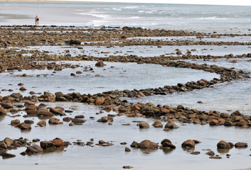 Ancient fish traps along the shore of a beach in South Africa
