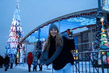 beautiful girl in winter hat near the Christmas tree, winter holidays, holiday and walks photo...