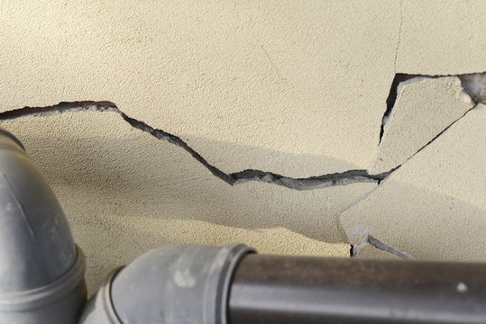 plaster wall with cracks. Building requiring repair .closeup