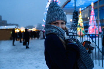beautiful girl in winter hat near the Christmas tree, winter holidays, holiday and walks photo...