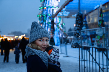 beautiful girl in winter hat near the Christmas tree, winter holidays, holiday and walks photo...
