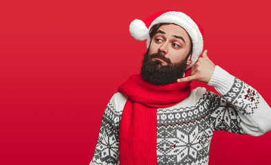 Bearded man making call gesture during Christmas party