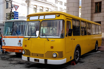 Naklejka na ściany i meble yellow passenger city bus in the Parking lot