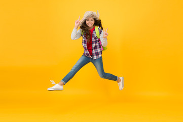 Keep moving. Winter season concept. Kid girl wear hat with ear flaps. Winter events at school. Winter entertainment and activities. Child active schoolgirl soft hat enjoy season. Winter vacations