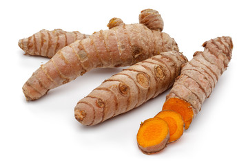Fresh turmeric with slices isolated on white background