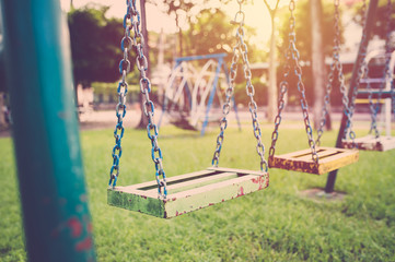 Empty chain swing in children playground. vintage filter