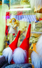 Little statues of angel and gnomes at stalls during Christmas Market in Riga, Latvia. Europe on winter. Street Xmas and holiday fair. Advent Decoration and Stalls with Crafts Items on Bazaar