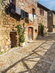 view to drying linen on the wall in italian city Monteriggioni in Tuscany in Italy